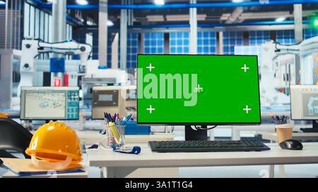 Chroma key mockup computer in empty photovoltaics factory used to diagnose malfunctioning systems. Isolated screen PC in solar panels manufacturing plant used for reducing downtime Stock Photo