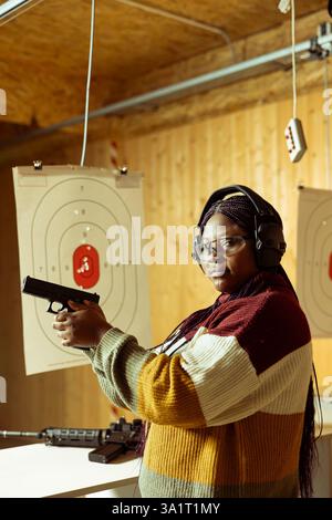 Portrait of shooting range client reloading rifle, preparing to shoot ...