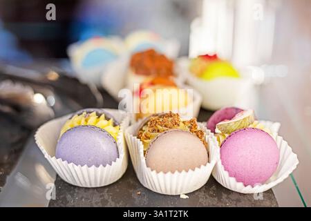 multicolored macaroons with filling in a bakery Stock Photo