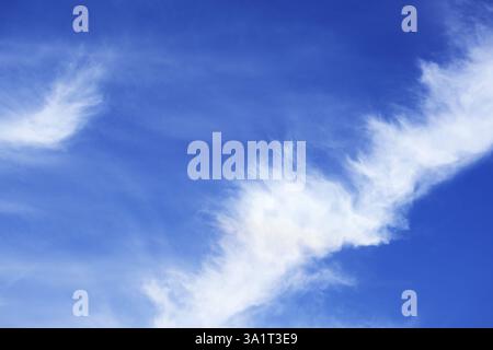 Beautiful white feathery clouds spreading on vivid blue sky Stock Photo