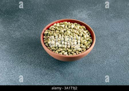 A bowlful of natural dried thyme seeds on gray background Stock Photo