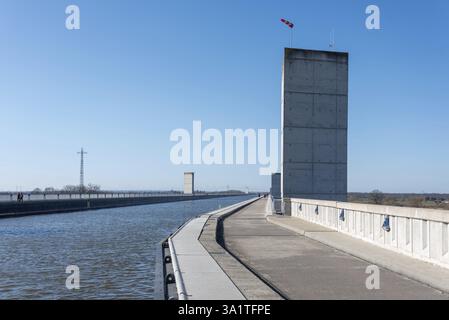 Canal with concrete walls and a high tower, a path on the left, blue sky above, Hohenwarthe, Saxony-Anhalt, Germany Stock Photo