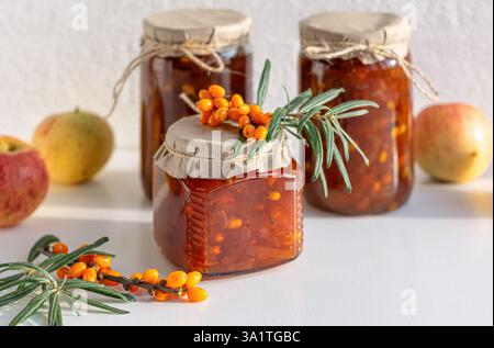 A collection of jars filled with golden seabuckthorn and apple jam. Close-up. Stock Photo