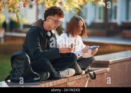 Two young students are together outdoors. Stock Photo