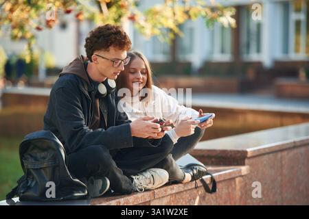 Two young students are together outdoors. Stock Photo