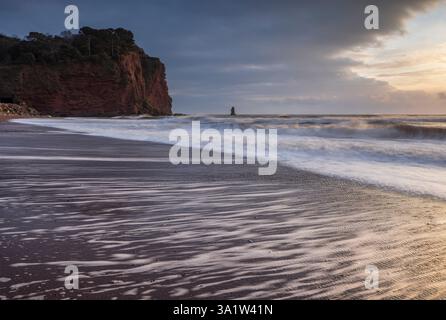 Waves breaking on Holcombe Beach at dawn, Teignmouth, Devon, England.  Winter (February) 2025. Stock Photo
