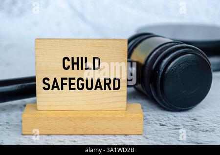 Child Safeguard text on wooden blocks with gavel background. Child safeguard concept. Stock Photo