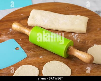 Toy cooking set featuring rolling pin and the dough Stock Photo