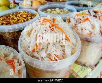 Transparent containers with sauerkraut on a market counter Stock Photo
