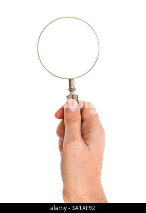 Person's hand holding magnifying glass isolated cutout on white background Stock Photo