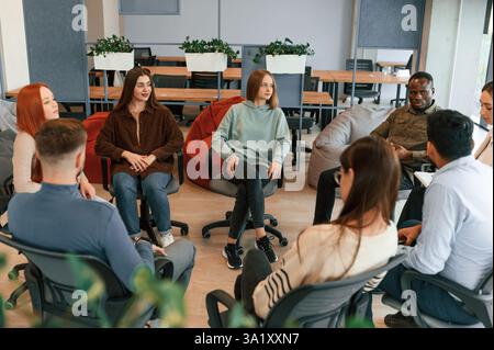 Therapy meeting in the circle together. Group of people. Stock Photo