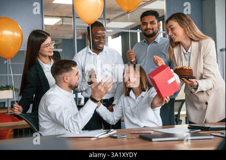 Employee having a birthday in the office, group of workers. Stock Photo