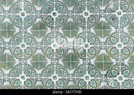Traditional decorative tiles with ornate green and white patterns in a repeating design. Stock Photo