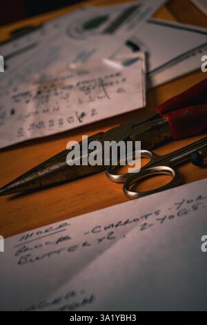 tools and paper with personal notes spread out on a table Stock Photo