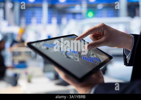 Solar panels manufacturing plant staff member developing new photovoltaic materials and technologies using tablet. Close up of photovoltaics factory expert conducting experiments on touchscreen device Stock Photo