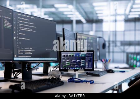 Computers in data center hosting rackmount ensuring faultless operations conditions. Close up of PC monitors and tablet on desk used for monitoring data center devices energy consumption Stock Photo