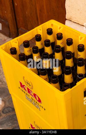 Limassol, Cyprus- December 20, 2025: KEO beer empty glass bottles in yellow crate Stock Photo