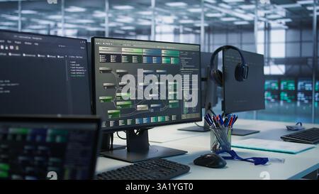 Close up of computer displays in empty data center establishment monitoring hardware energy consumption. PC screens on server hub office desk showing programming software Stock Photo