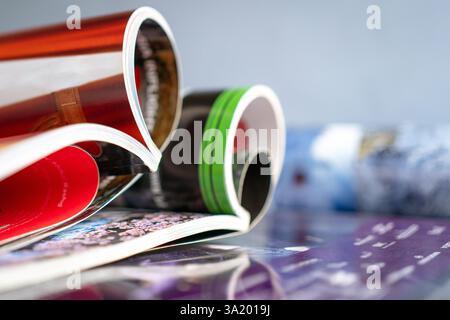 Stack and rolled magazines, copy space. Stock Photo