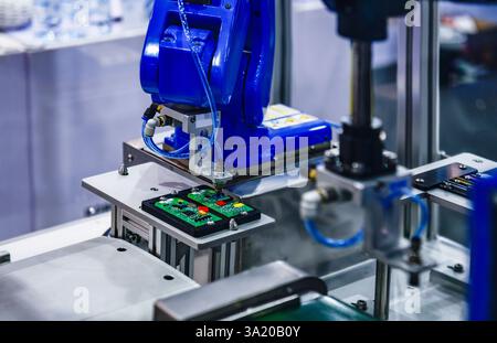 Automatic robots for assembling electronic circuit boards in factories Stock Photo