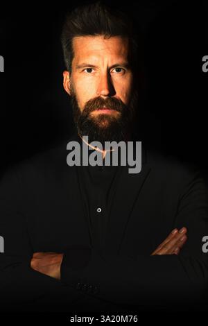 Portrait of Caucasian man with beard on black background Stock Photo