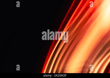 Abstract red-orange uneven diagonal waves glowing on black background with space for text. Design element. Stock Photo