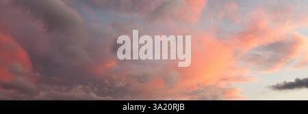 Sky banner with pink and grey coloured clouds at sunset and space for text Stock Photo