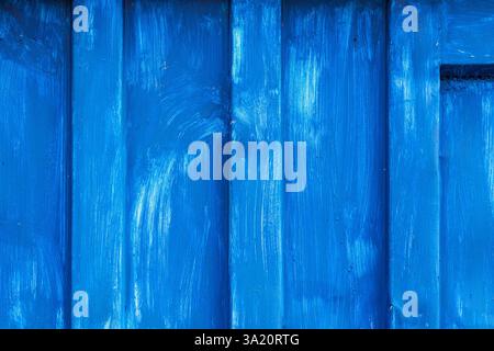 Close-up of a vivid and striking blue painted metal surface, showcasing visible brushstrokes and texture. Perfect for design projects or as a vibrant Stock Photo