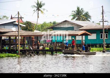 Thai people workers and helmsman long tail boat sailing in Khlong Bangkok Noi Canal keeping trash waste cleaning river at Wat Utthayan temple at Bang Stock Photo