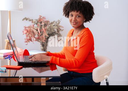 African American student studying at home, using laptop at modern workspace Stock Photo
