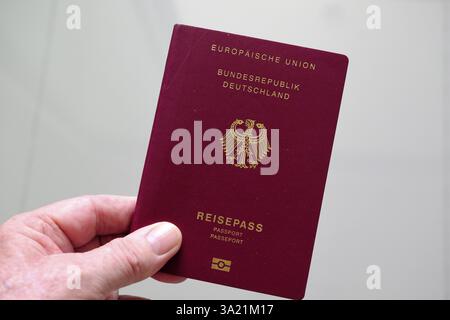 Hand holds German passport Stock Photo