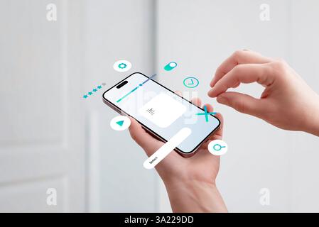 Hand holding smartphone, assembling UI elements on screen, concept of mobile app interface design and user experience Stock Photo