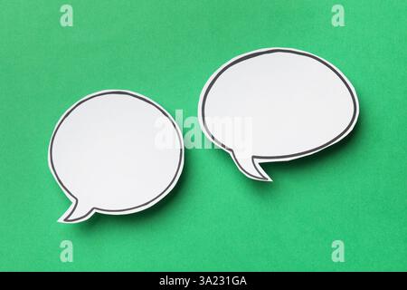 Blank speech bubbles on green background, top view. Space for text Stock Photo