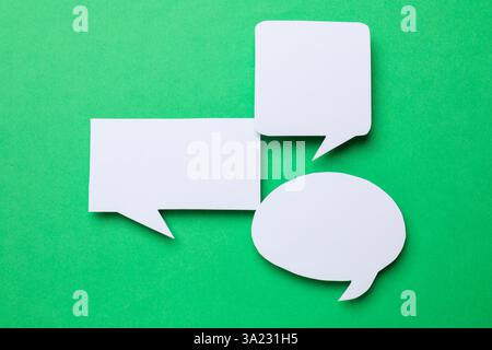 Blank speech bubbles on green background, top view. Space for text Stock Photo