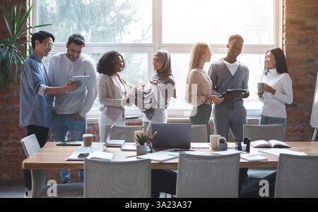 Friendly business team talking while having break Stock Photo