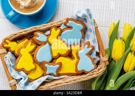 Easter Scene with Bunny-Shaped Gingerbread Cookies, Yellow Tulips, and Coffee Cup Stock Photo