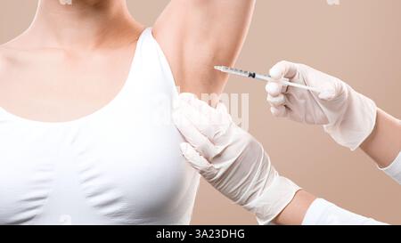 Woman receiving underarm treatment against hyperhidrosis, closeup Stock Photo