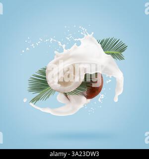 coconuts with palm leaves and milk splash on a light blue background. Stock Photo