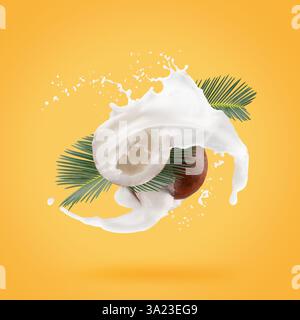 coconuts with palm leaves and milk splash on a yellow background. Stock Photo