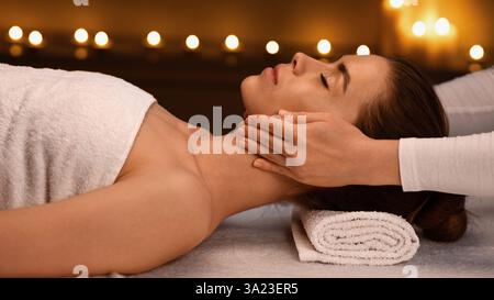 Spa therapist making relaxing acupressure massage for young lady Stock Photo