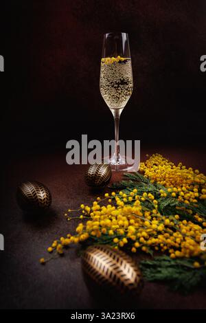 Elegant Easter still life with champagne and mimosa flowers Stock Photo