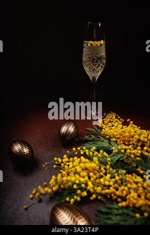 Elegant Easter celebration with champagne and mimosa flowers Stock Photo