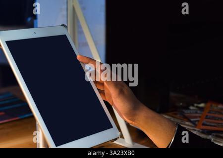 Restaurant employee using POS point of sale system on digital tablet Stock Photo
