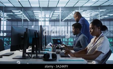Admin arriving in server room, starting work on developing disaster recovery plans ensuring minimal downtime. Employee entering data center, beginning job shift, monitoring performance, camera A Stock Photo