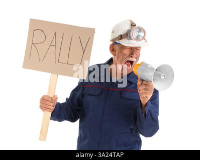 Protesting mature miner man with placard shouting into megaphone on white background Stock Photo