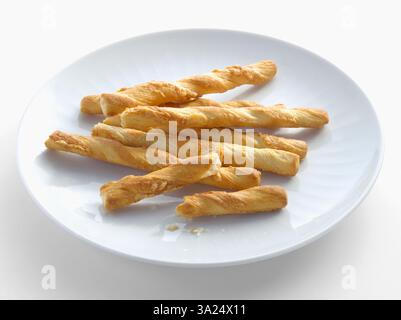 Puff pastry and cheese sticks on a white plate Stock Photo