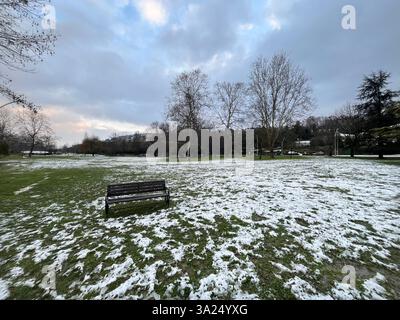 One park bench in public park at snowy day. Stock Photo