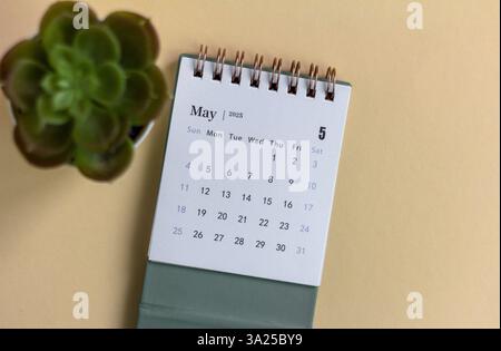 Hello, desk calendar for planning for May 2025 on a beige background Stock Photo