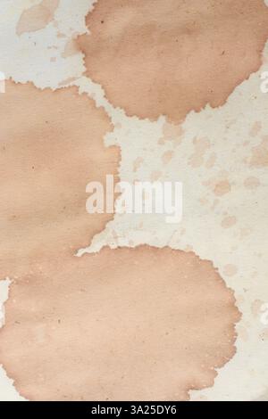 brown color coffee or tea stains on piece of old paper surface, close-up view taken straight from above with copy space Stock Photo
