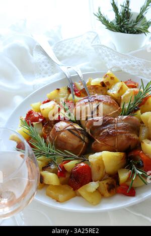 Meat rolls with bacon and rosemary baked vegetables (potatoes, tomatoes, peppers). Directly above. Stock Photo